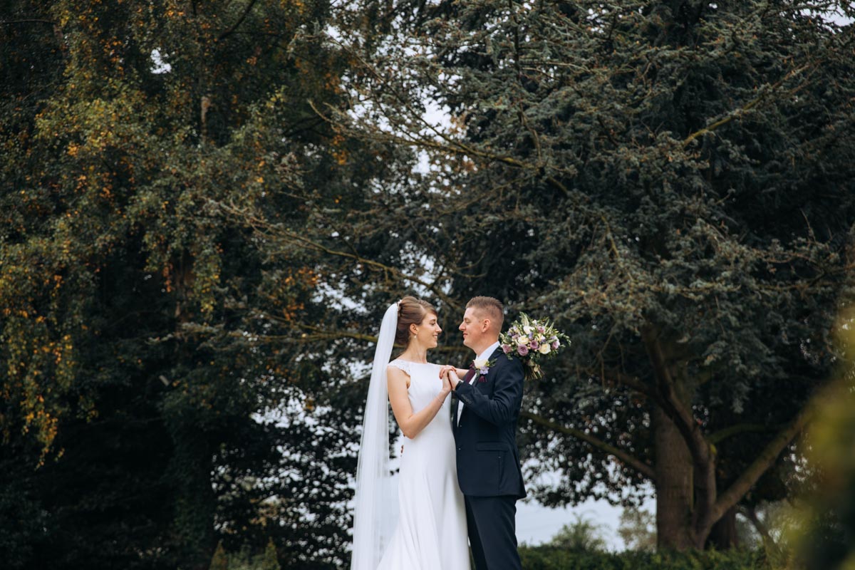 bride and groom in gardens at thornton hall hotel