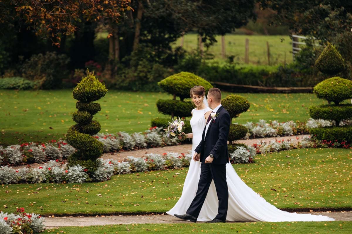 bride and groom walking at thornton hall hotel