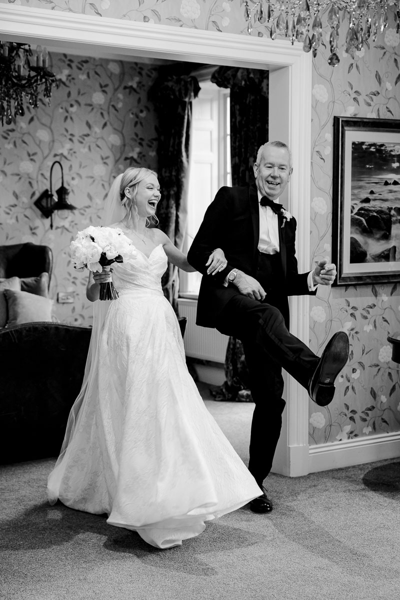 Guests celebrating on the lawn at Eaves Hall Wedding Venue